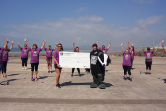 #WILDFundraiser Half Marathon holding a big cheque 