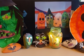 Pebbles and plates decorated for Halloween