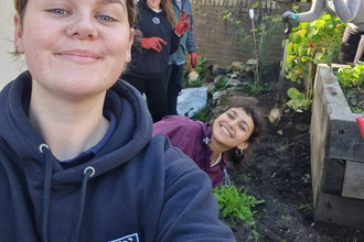 Marianne with a group of people in a garden. 