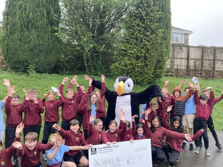 A group of a school children with our puffin mascot. 